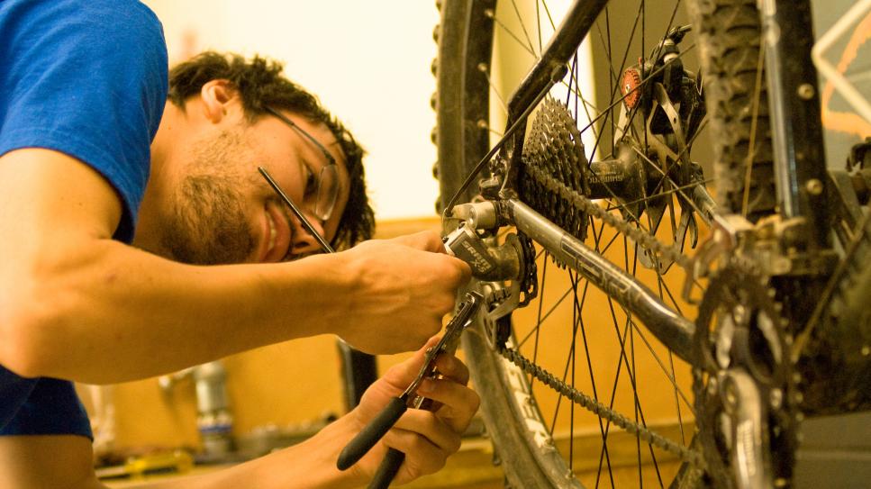 worker repairing a bike in the bike shop